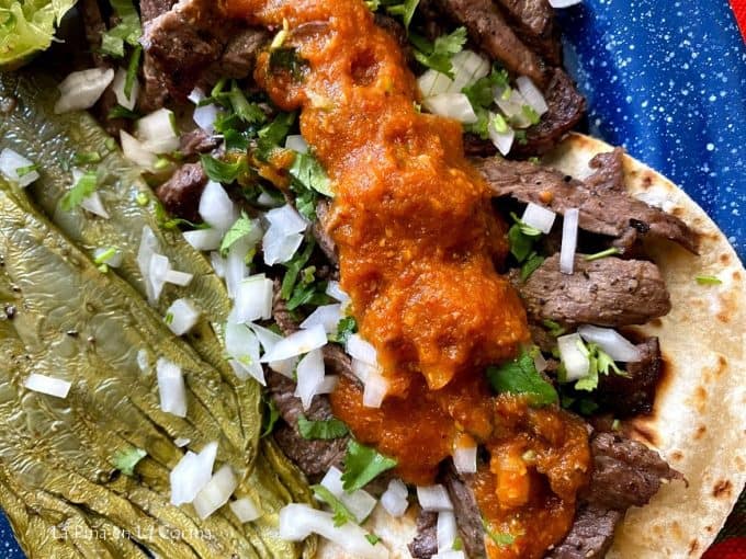 close up of salsa on top of a steak taco