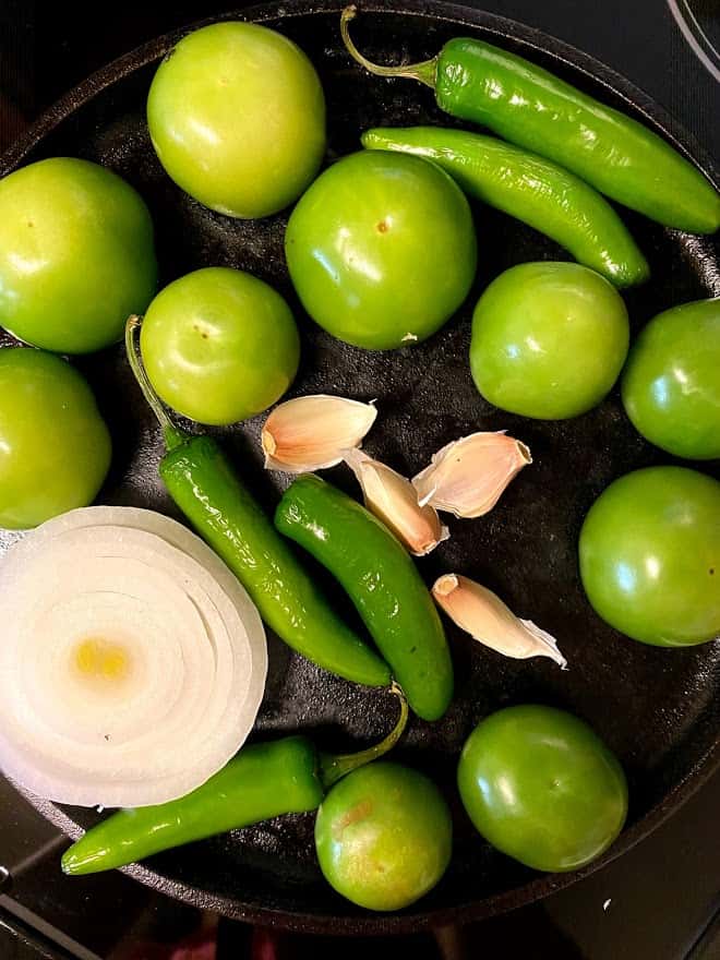salsa ingredients on cast iron comal heating up