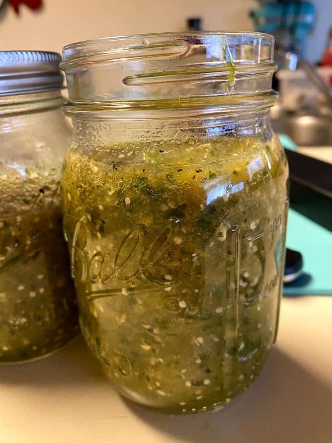 close up of roasted salsa verde in a jar