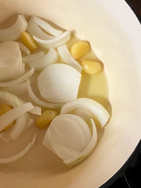 Onions and garlic on dutch oven pot