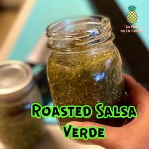 jar of roasted salsa verde being held up with title