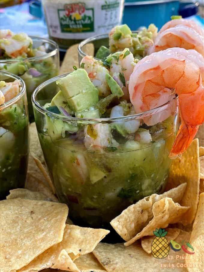 ceviche served in a glass with fresh shrimp garnish on rim