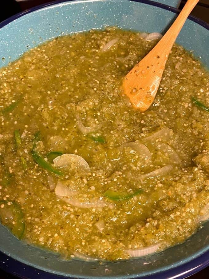fresh salsa verde simmering in skillet, close up