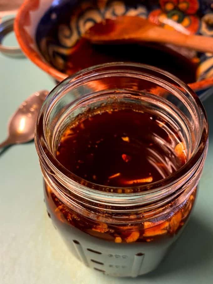 close up of garlic chile oil in an open jar