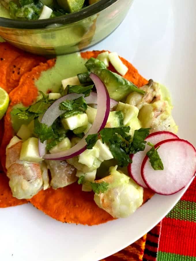 close up of shrimp ceviche on red tostada