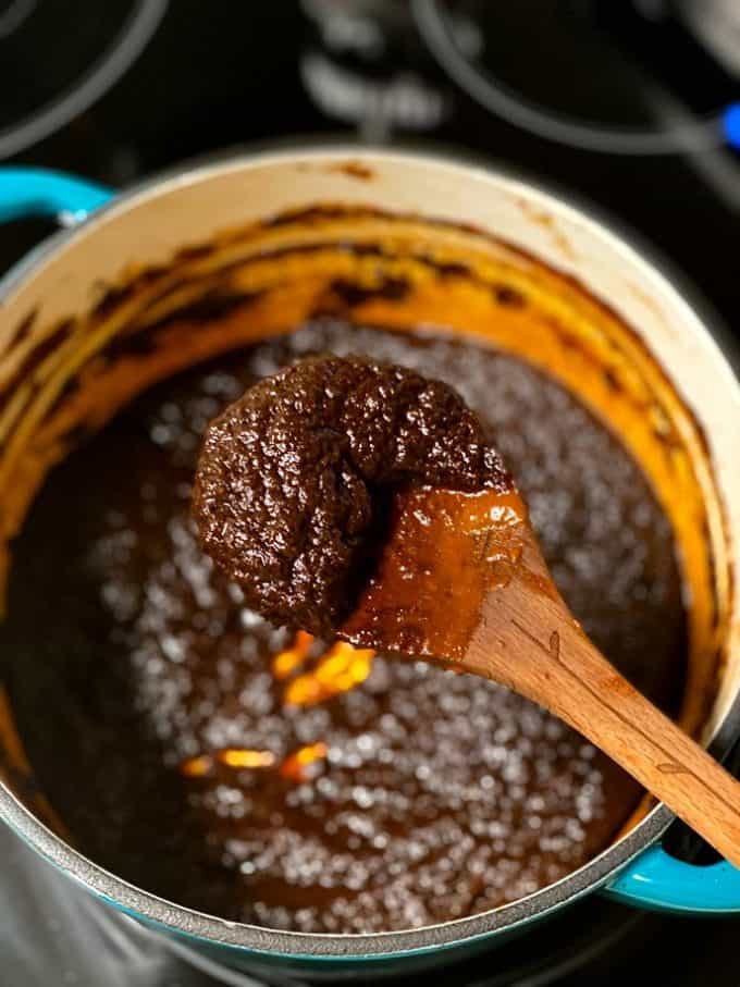 salsa negra reduced and dark on a wooden spoon