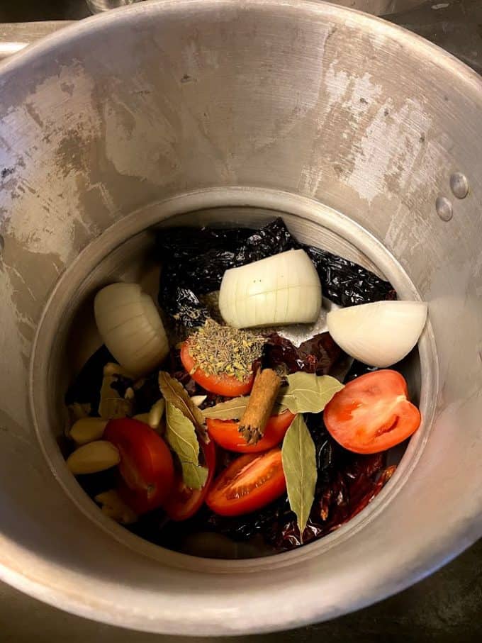 ingredients for consomme at the bottom of steamer pot