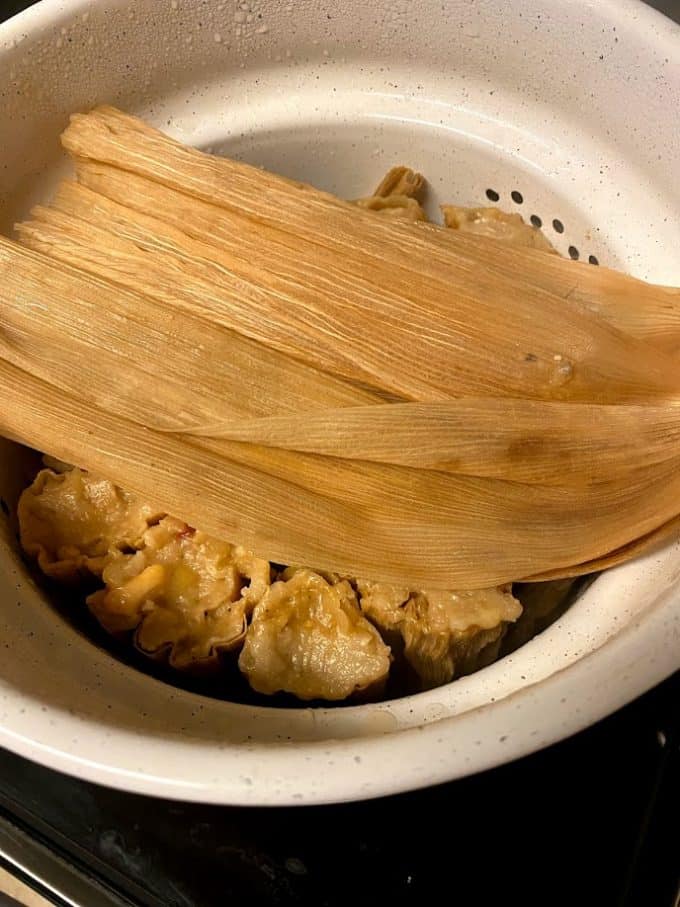 open steamer pot with fresh cooked tamales
