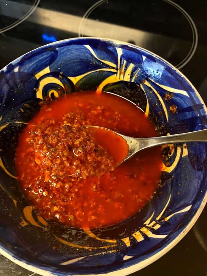 red chile garlic mojo in a large bowl with spoon