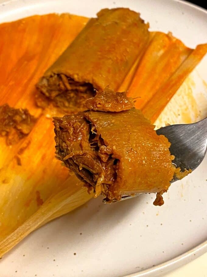 red chile pork tamal up close on a fork