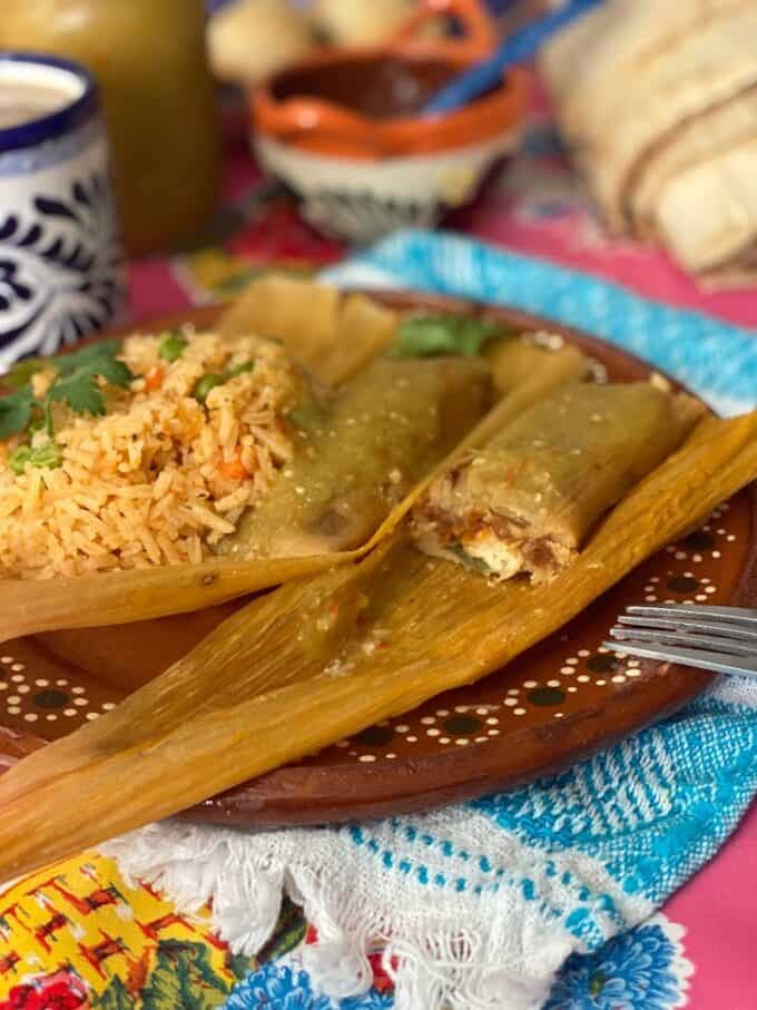 bean, cheese and jalapeño tamales plated with rice