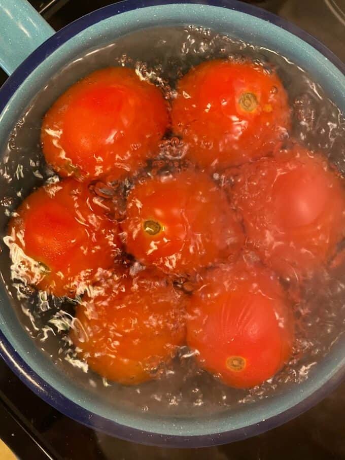 tomatoes up close boiling in water
