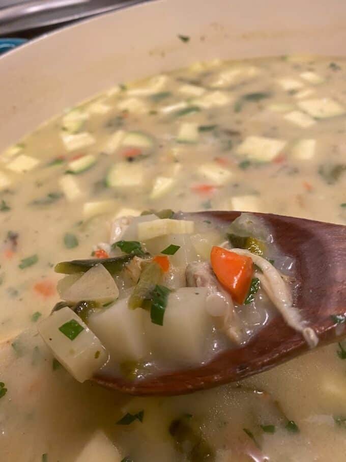 close up of chowder on wooden spoon