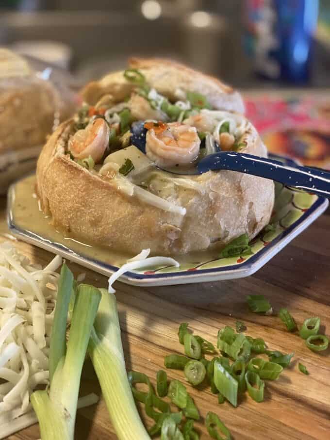 green chile seafood chowder in a small bread bowl