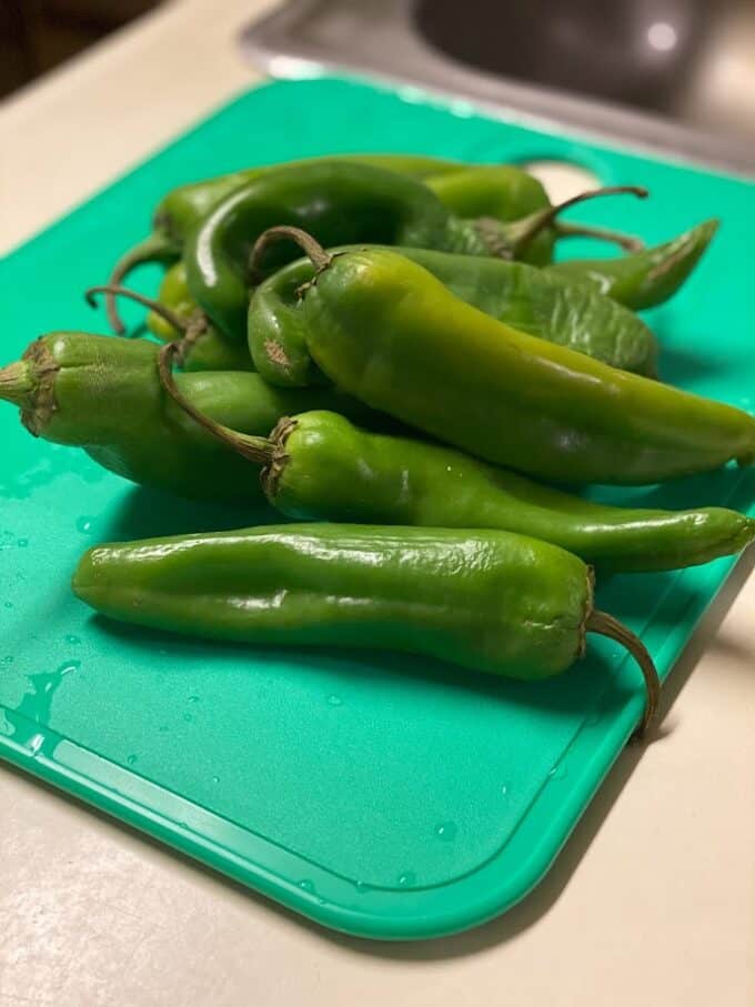 fresh green chiles on cutting board