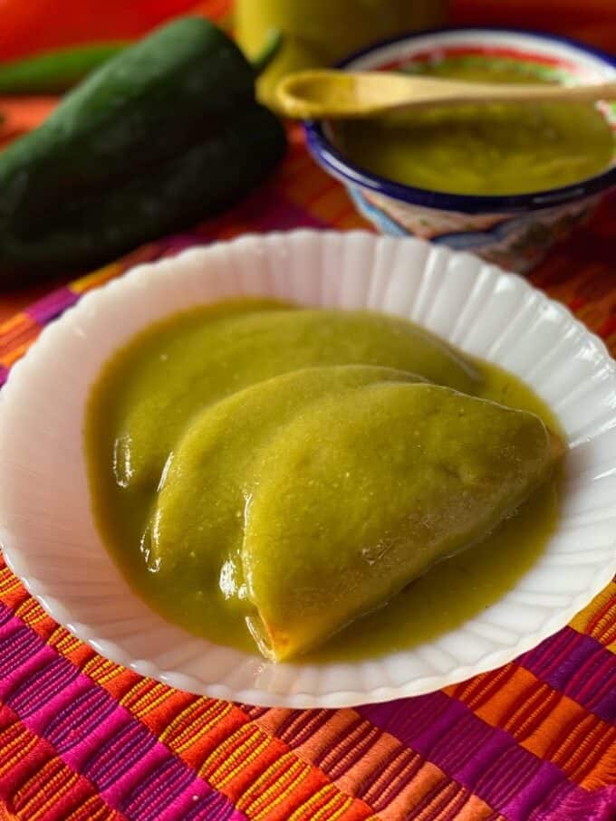 tacos dorados covered in chile verde sauce close up