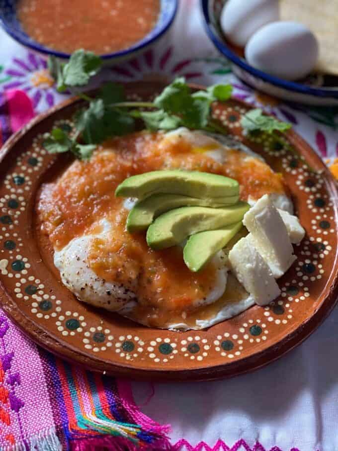 close up of huevos rancheros on mexican plate