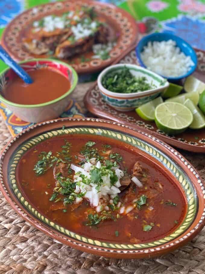 birria with consomme in the front