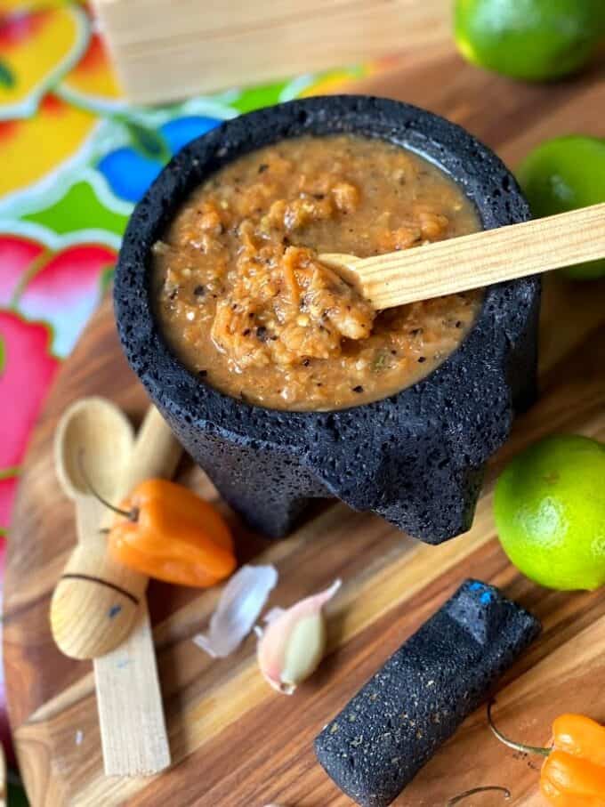habanero salsa in molcajete with wooden spoon