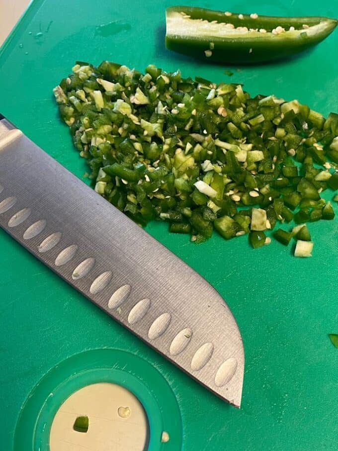 finely diced jalapeños on cutting board