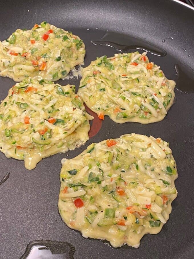 Fritters cooking in nonstick skillet