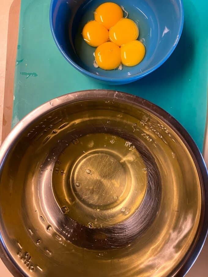 egg whites and egg yolks in separate bowls