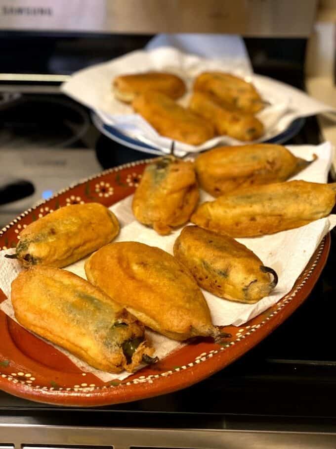 Fried rellenos on paper towel lined plate