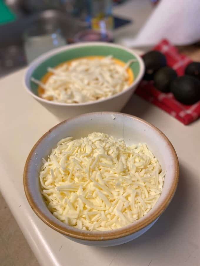 Oaxaca cheese and Chihuahua cheese in separate bowls
