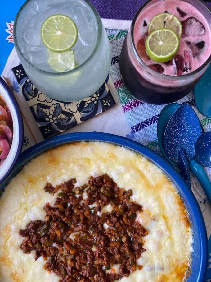 queso fundido in skillet with margaritas