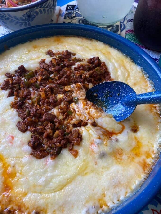 queso fundido in skillet with spoon