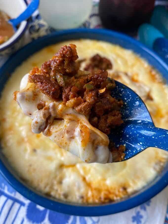 close up of queso fundido on spoon