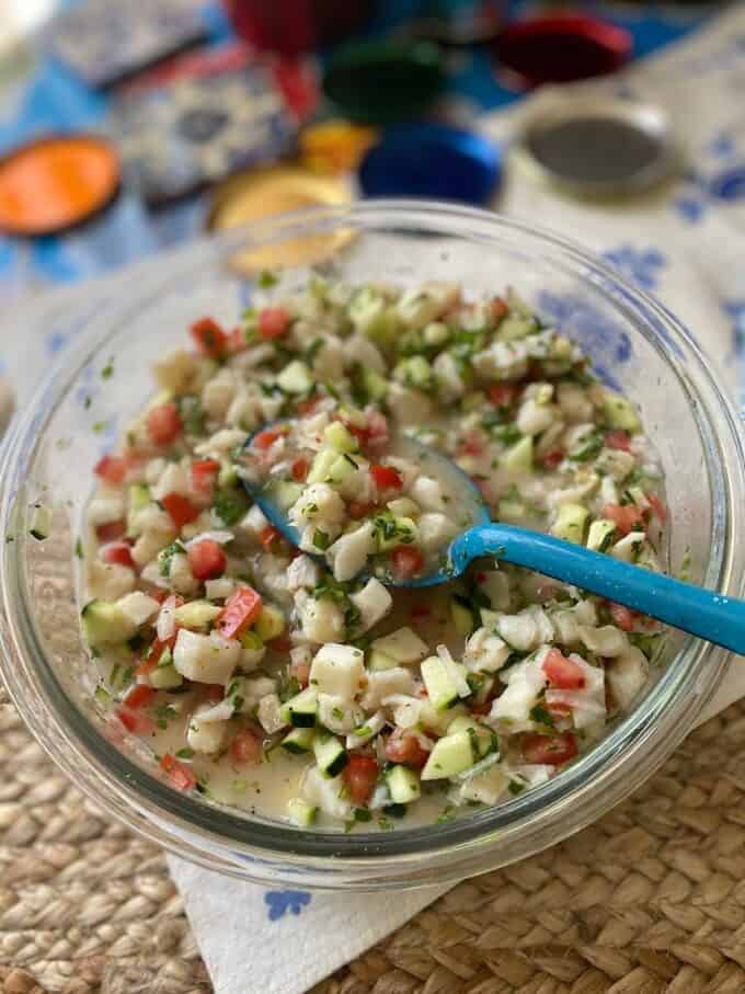 fish ceviche in large bowl with metal spoon