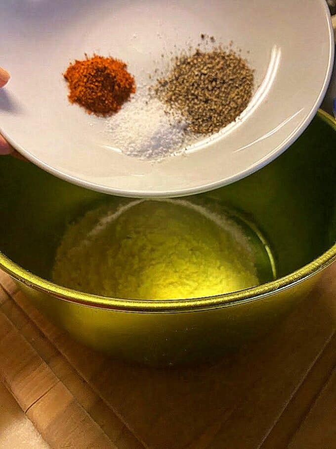 spices going into bowl with flour