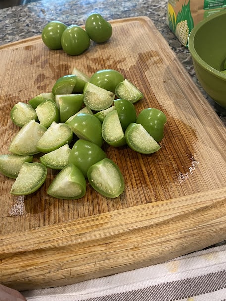 roughly chopped fresh tomatillos on cutting board