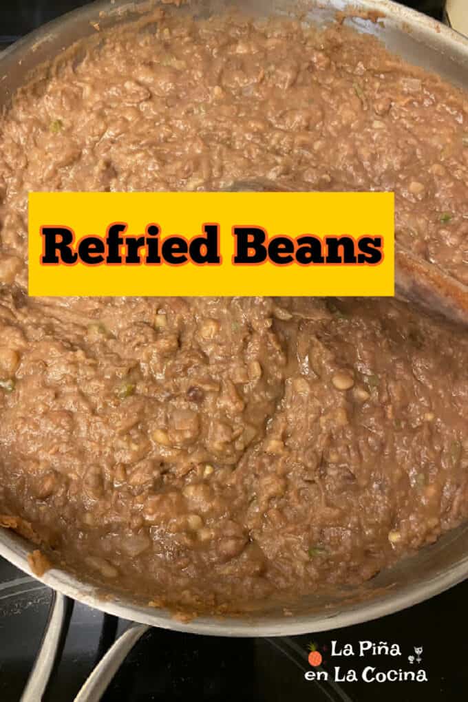 pinterest image of refried beans in skillet with text