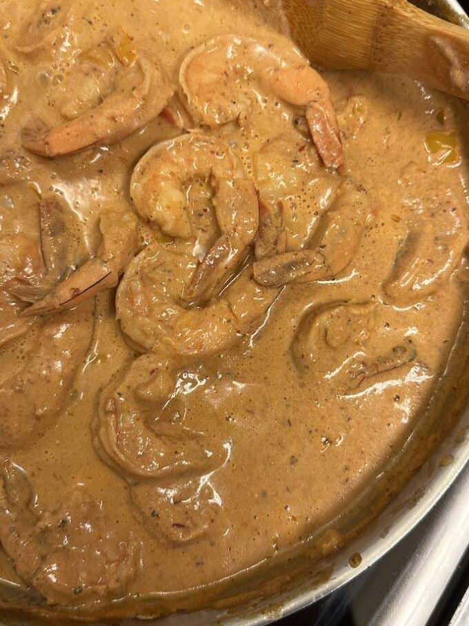 close up of chipotle shrimp in skillet before adding pasta