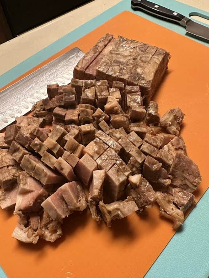 cubed pressed pork on cutting board