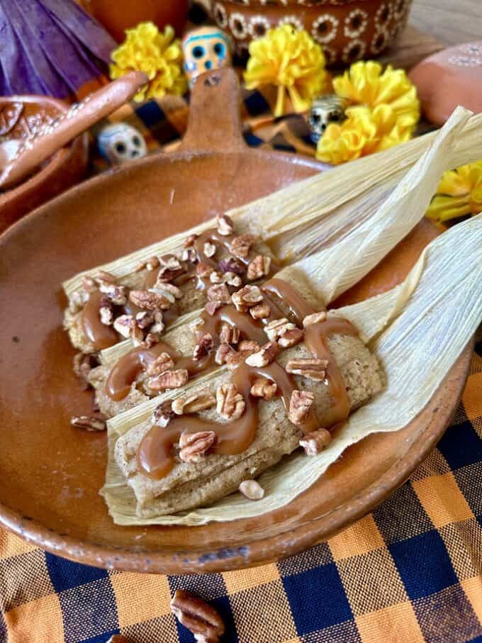 pumpkin tamales plated with garnish