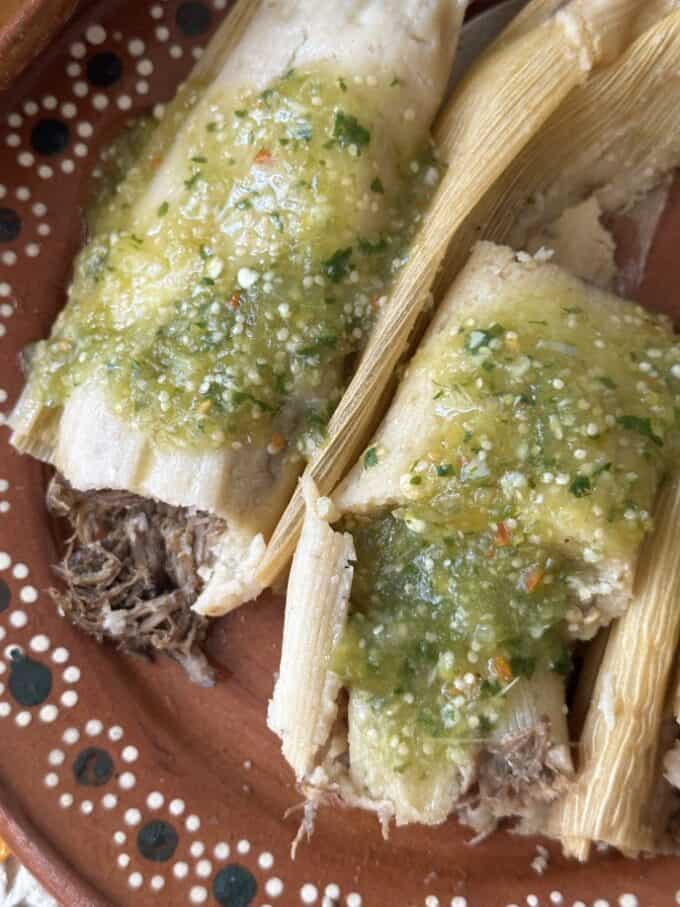 plated beef tamales with salsa garnish