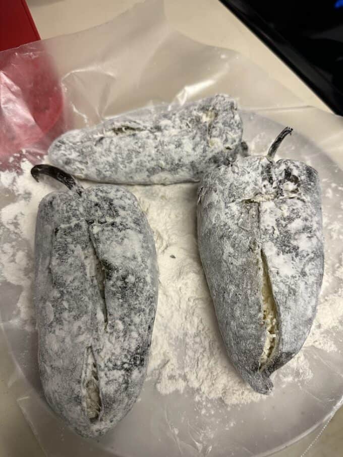 dusting the rellenos with flour
