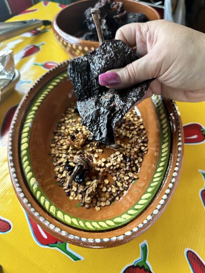 removing seeds and stems from the chile ancho pods