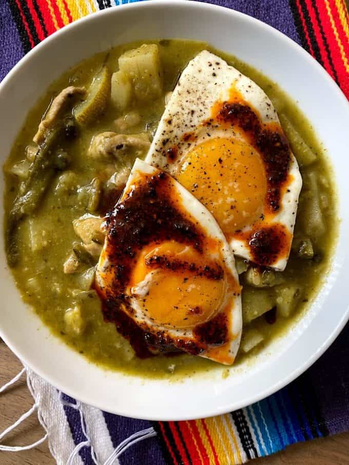 chicken stew with two sunny side up eggs and salsa macha 