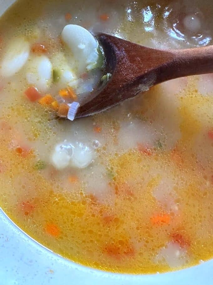 fava bean soup close up with wooden spoon