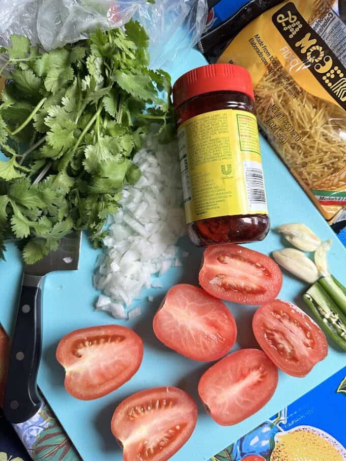 ingredients for fideo on cutting board