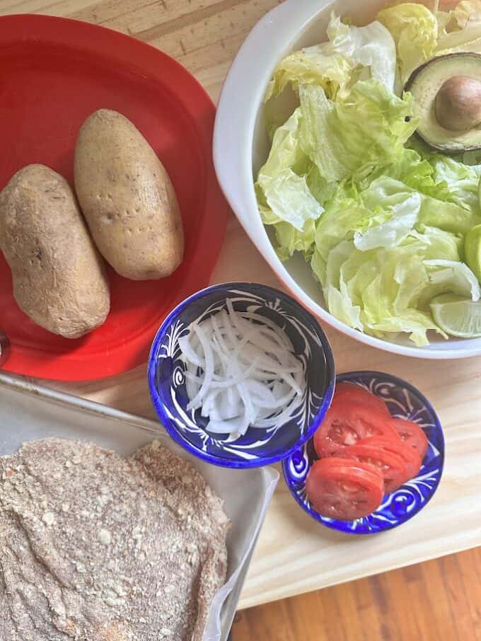 ingredients for simple salad and cooked potatoes