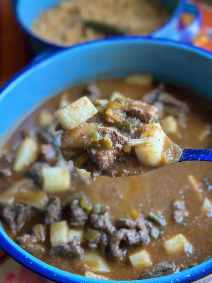 stewed mexican beef and potato on a large spoon