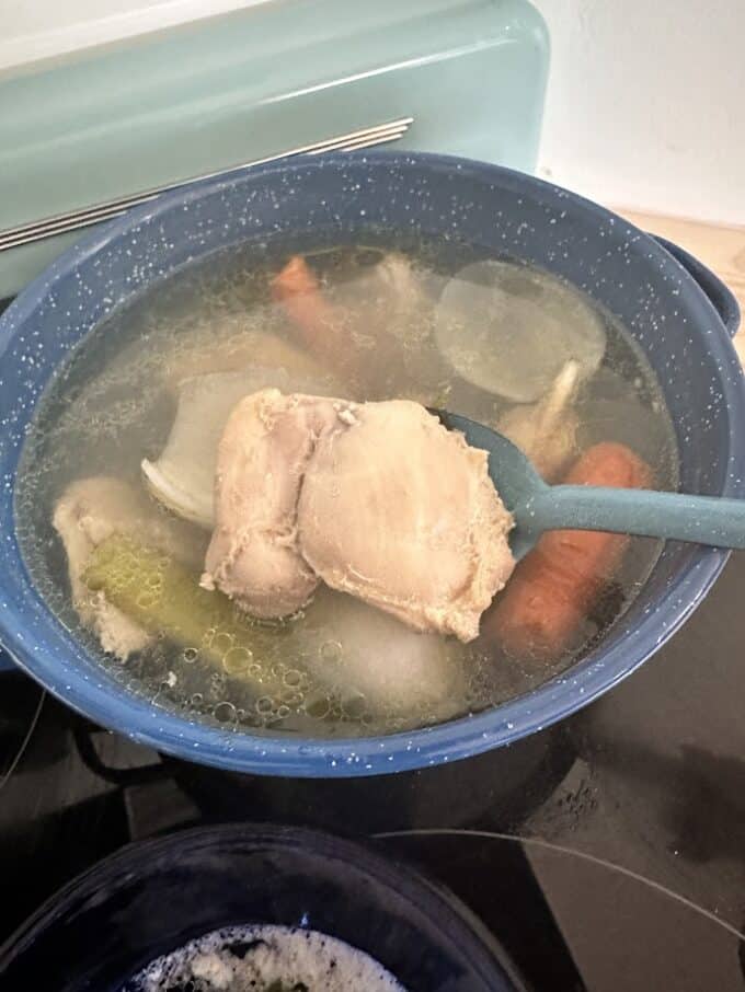 preparing chicken stock with chicken thighs and vegetables