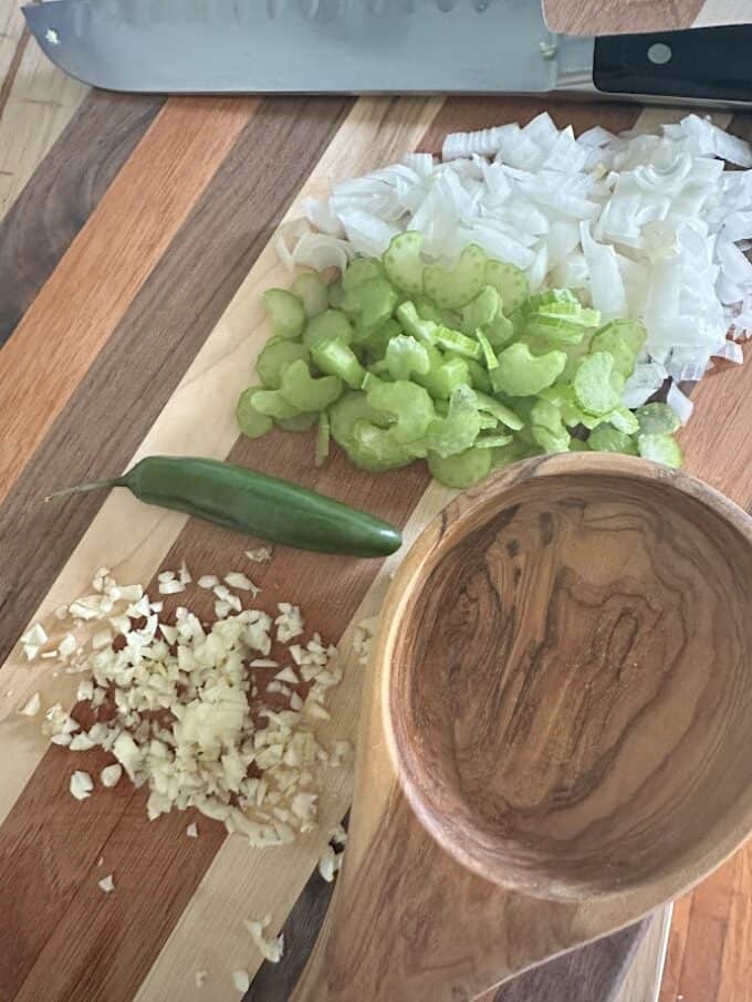 fresh ingredients for the sopa. Onion, celery, garlic and whole serrano pepper