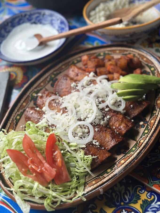 plated enchiladas with fresh garnish