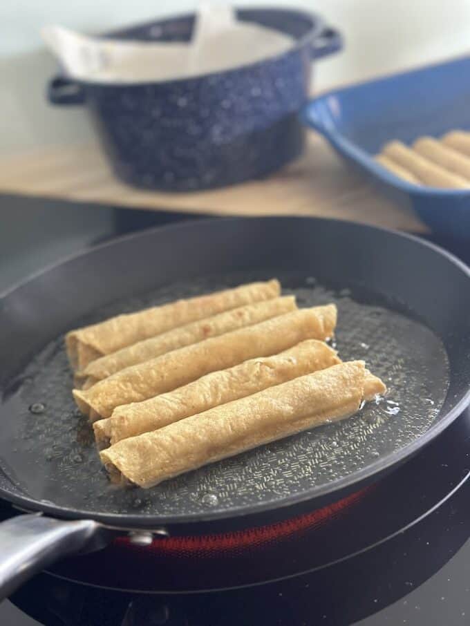 taquitos in the oil frying